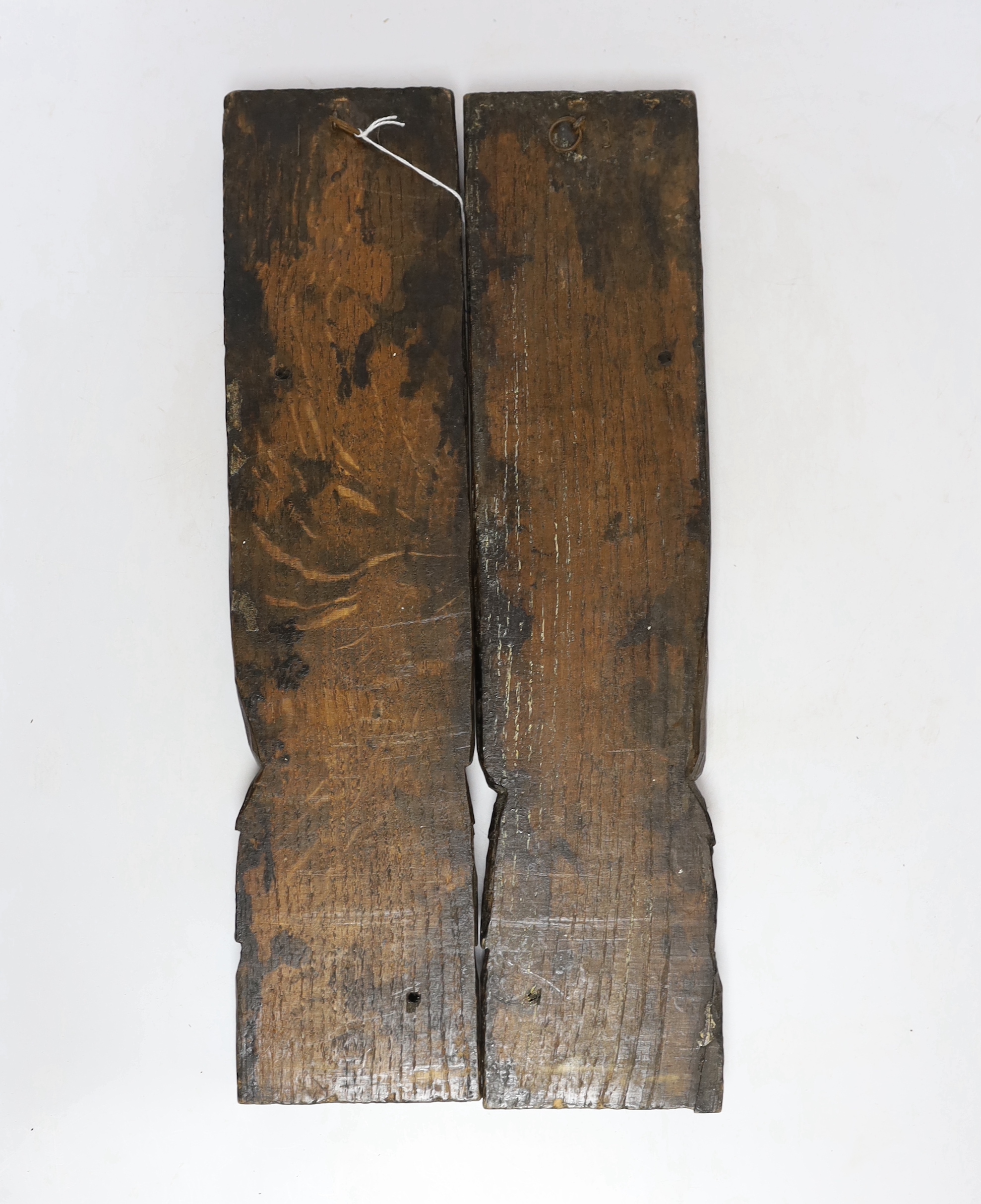 A pair of 17th century carved oak figural jambs, 43.5cm